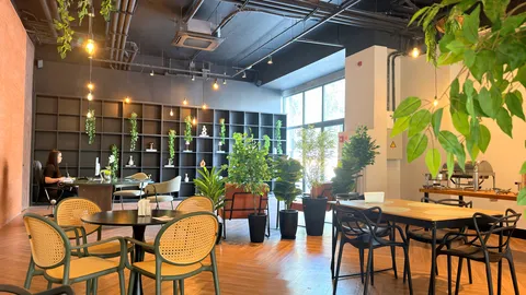 Reception and restaurant at Heritage X, with tables, plants and natural light
