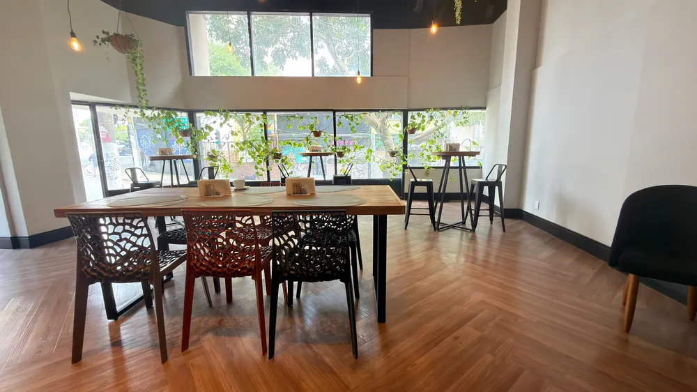Reception and restaurant at Heritage X, with tables, plants and natural light