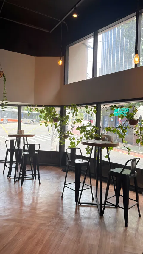Reception and restaurant at Heritage X, with tables, plants and natural light