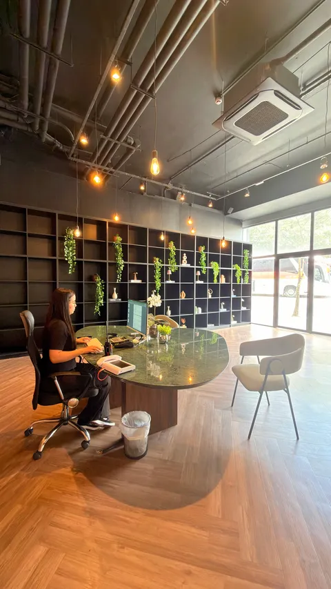 Reception and restaurant at Heritage X, with tables, plants and natural light