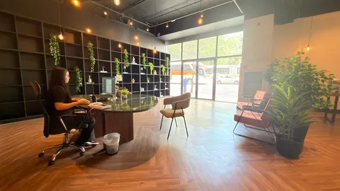 Reception and restaurant at Heritage X, with tables, plants and natural light