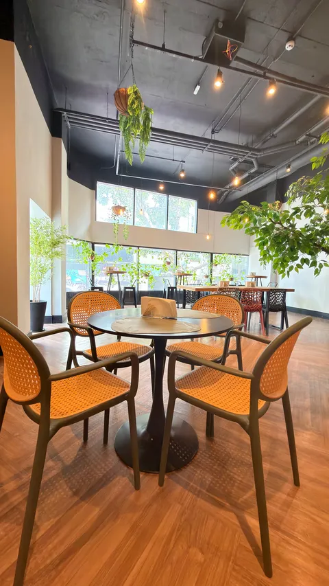 Reception and restaurant at Heritage X, with tables, plants and natural light