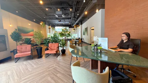 Reception and restaurant at Heritage X, with tables, plants and natural light