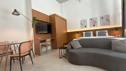 Studio at Heritage X, with a king bed, living area and equipped kitchen