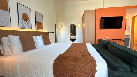 Studio at Heritage X, with a king bed, living area and equipped kitchen