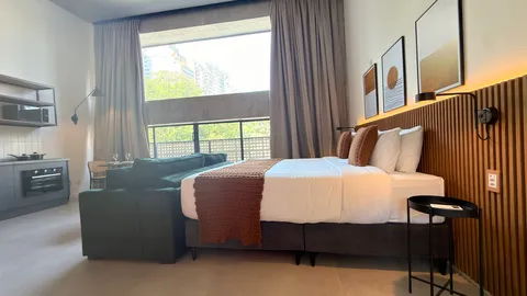 Studio at Heritage X, with a king bed, living area and equipped kitchen