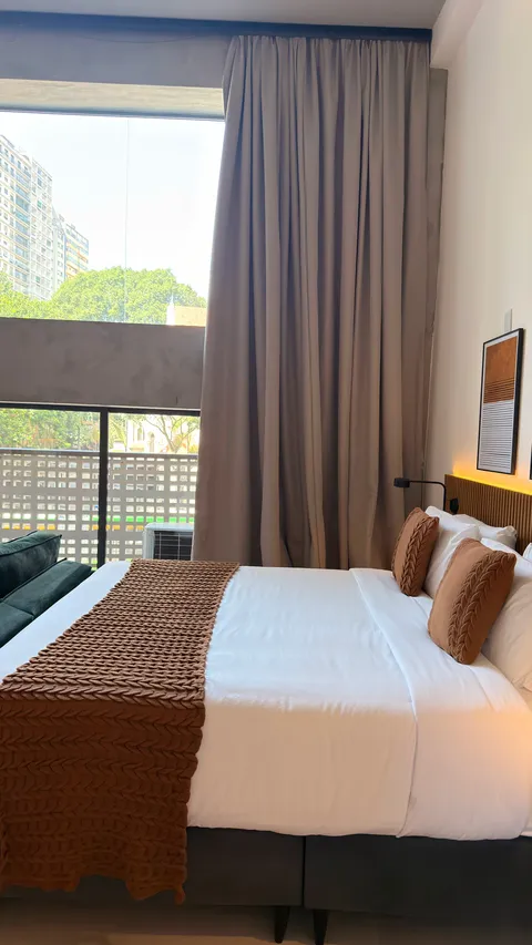 Studio at Heritage X, with a king bed, living area and equipped kitchen