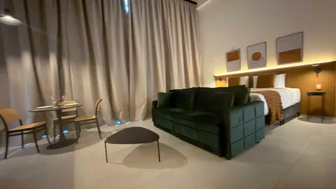 Studio at Heritage X, with a king bed, living area and equipped kitchen
