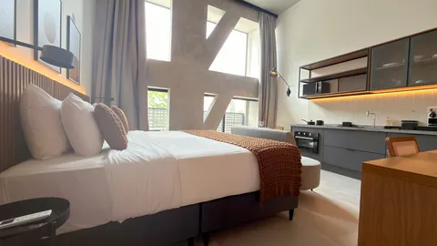 Studio at Heritage X, with a king bed, living area and equipped kitchen