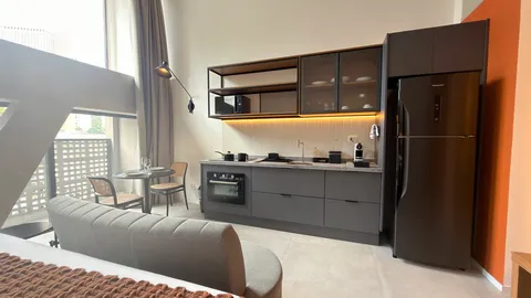 Studio at Heritage X, with a king bed, living area and equipped kitchen
