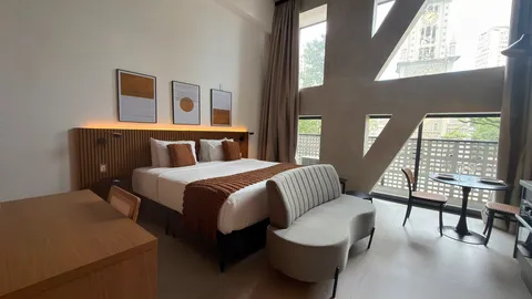 Studio at Heritage X, with a king bed, living area and equipped kitchen
