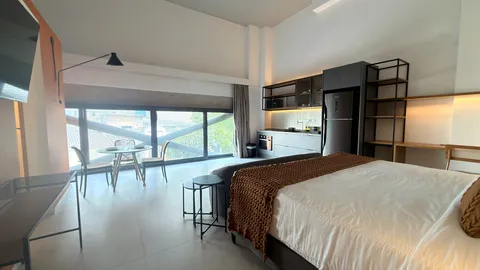 Studio at Heritage X, with a king bed, living area and equipped kitchen