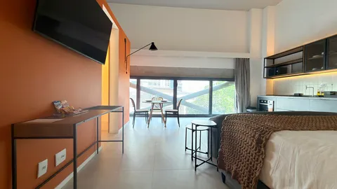 Studio at Heritage X, with a king bed, living area and equipped kitchen